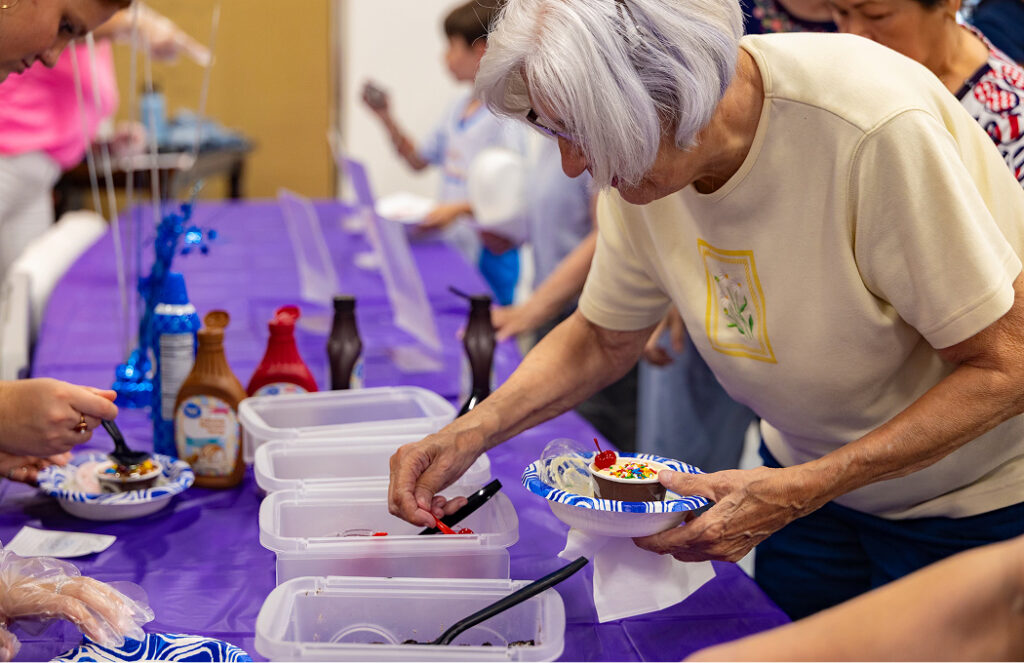 senior picking ice cream toppings