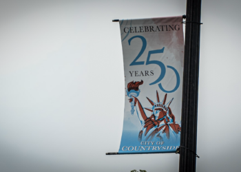 A street banner attached to a lamp post reads "Celebrating 250 Years" and "City of Countryside," with a illustration of the Statue of Liberty against a light blue background.