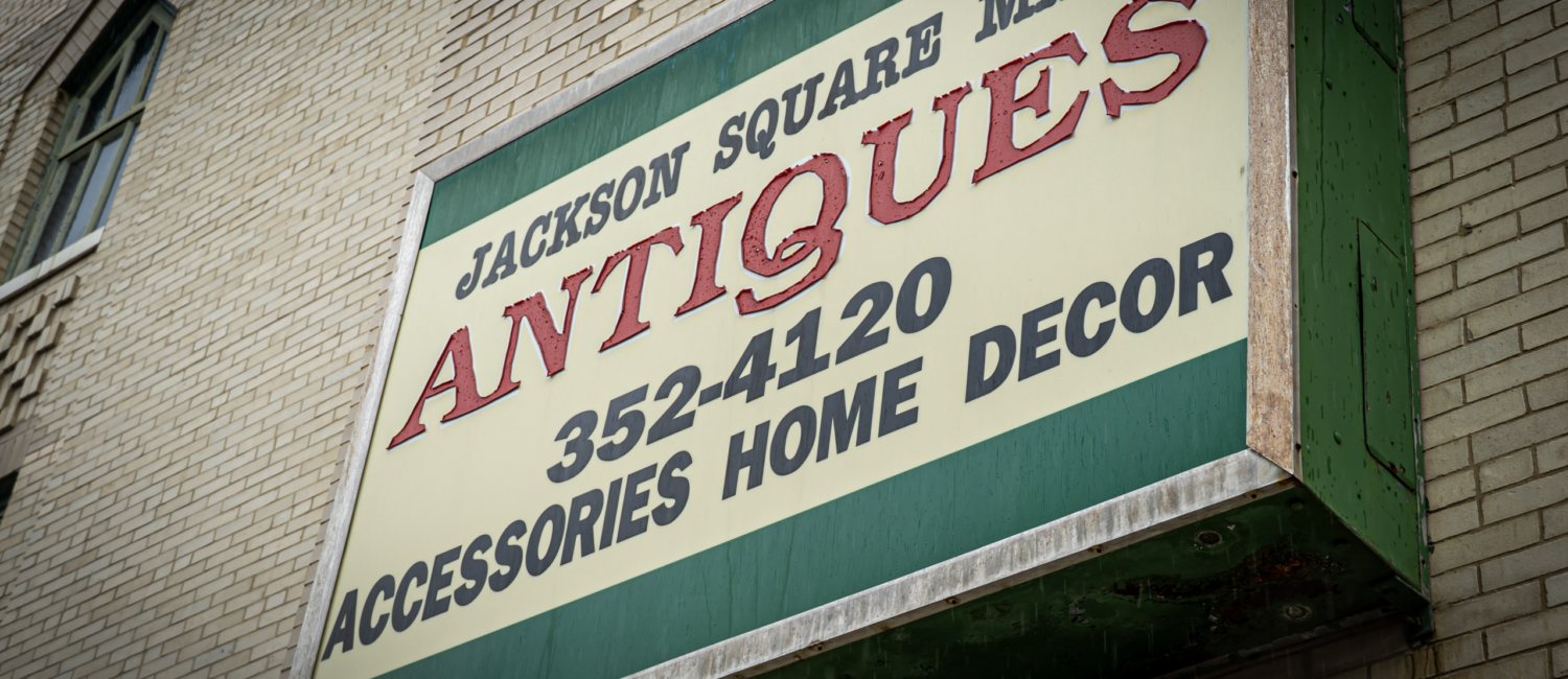 Exterior sign for Jackson Square Mall Antiques advertising accessories, home decor, and the phone number 352-4120.