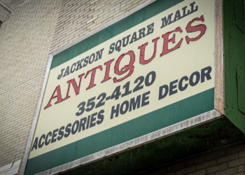 Exterior sign for Jackson Square Mall Antiques advertising accessories, home decor, and the phone number 352-4120.